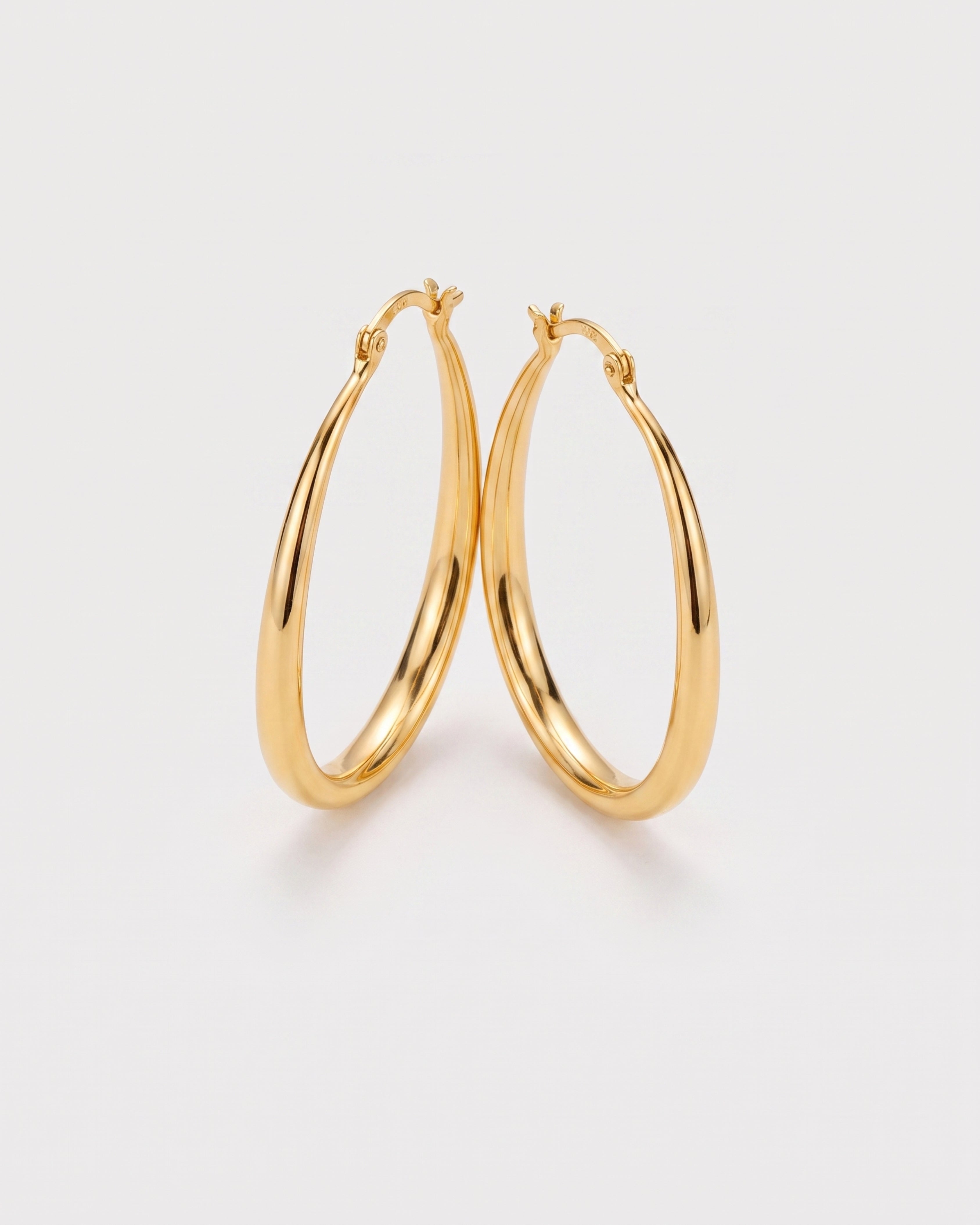Geometric Oval Earrings in gold — three-quarter view, RABUKO