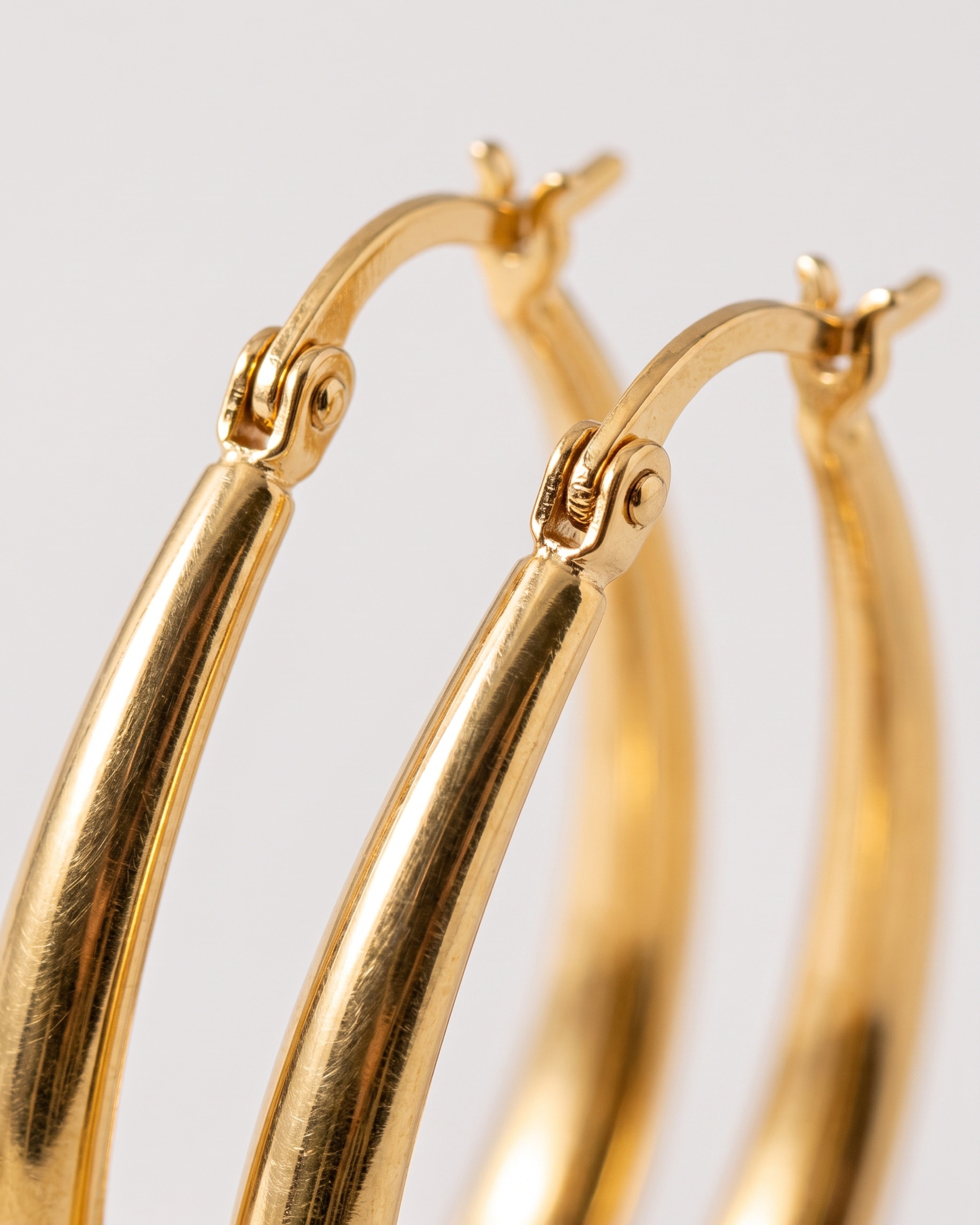 Geometric Oval Earrings in gold — macro detail, RABUKO