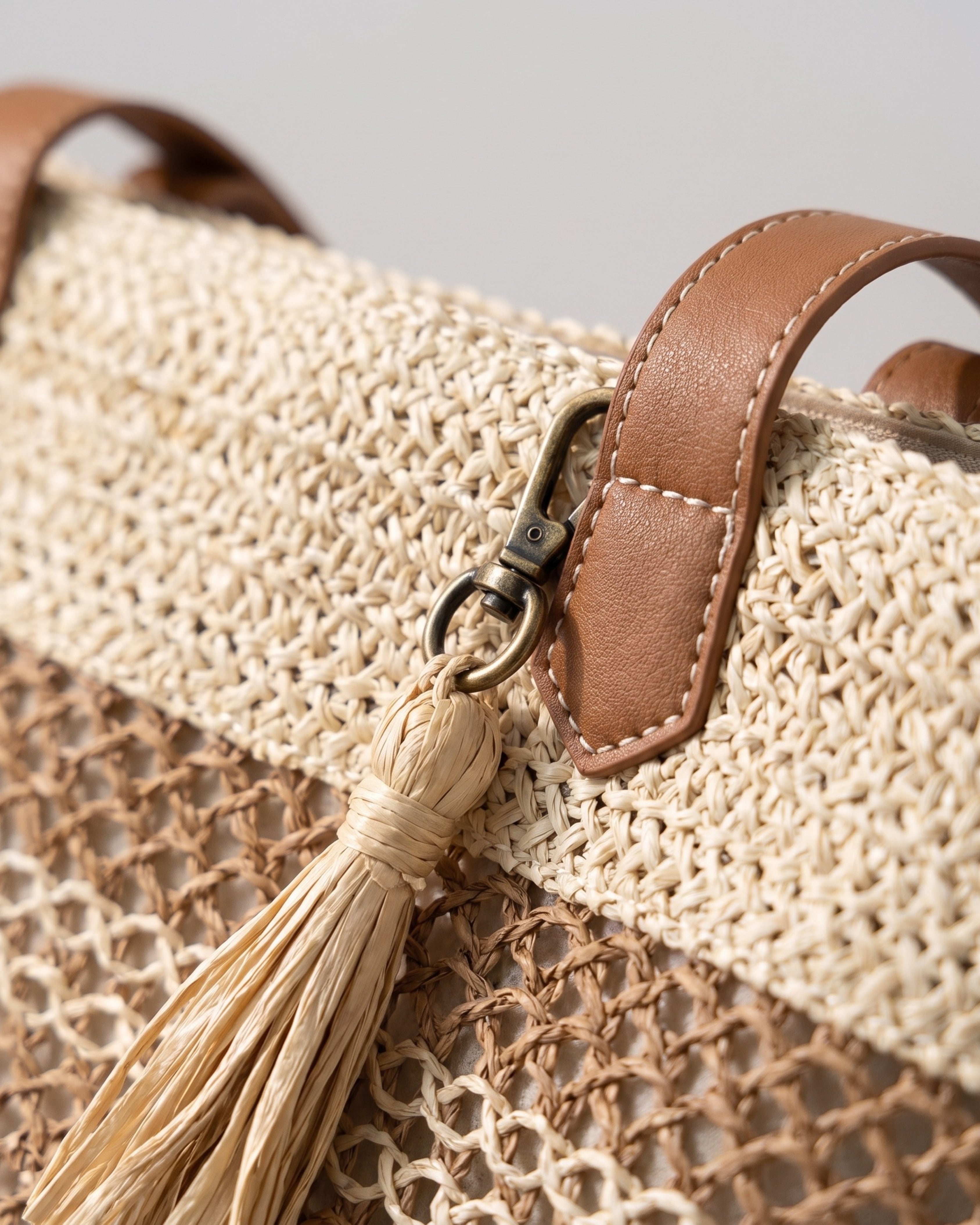 Tasseled Straw Tote Bag in beige — tassel detail, RABUKO