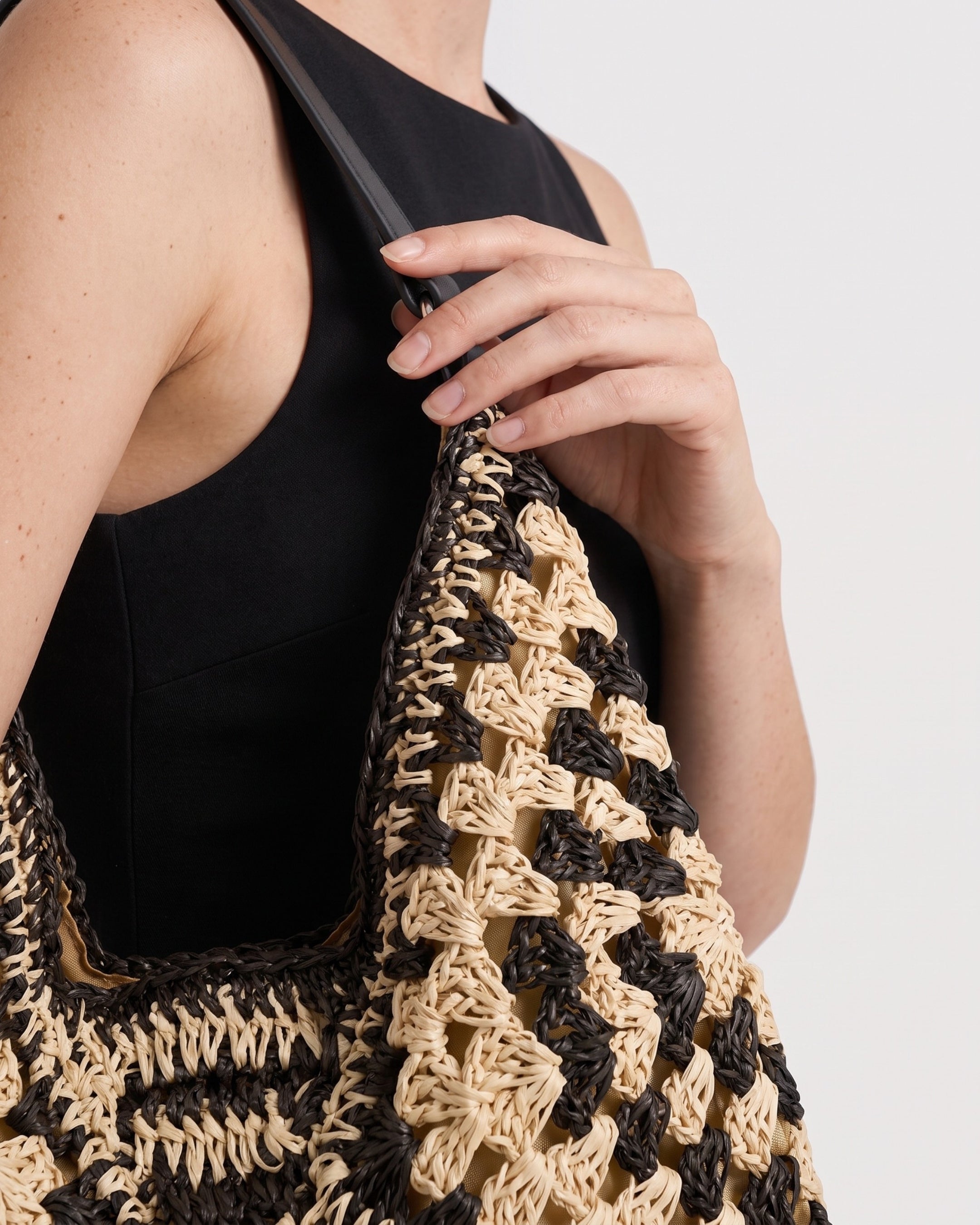 Cutout Straw Shoulder Bag in black khaki — back view, RABUKO