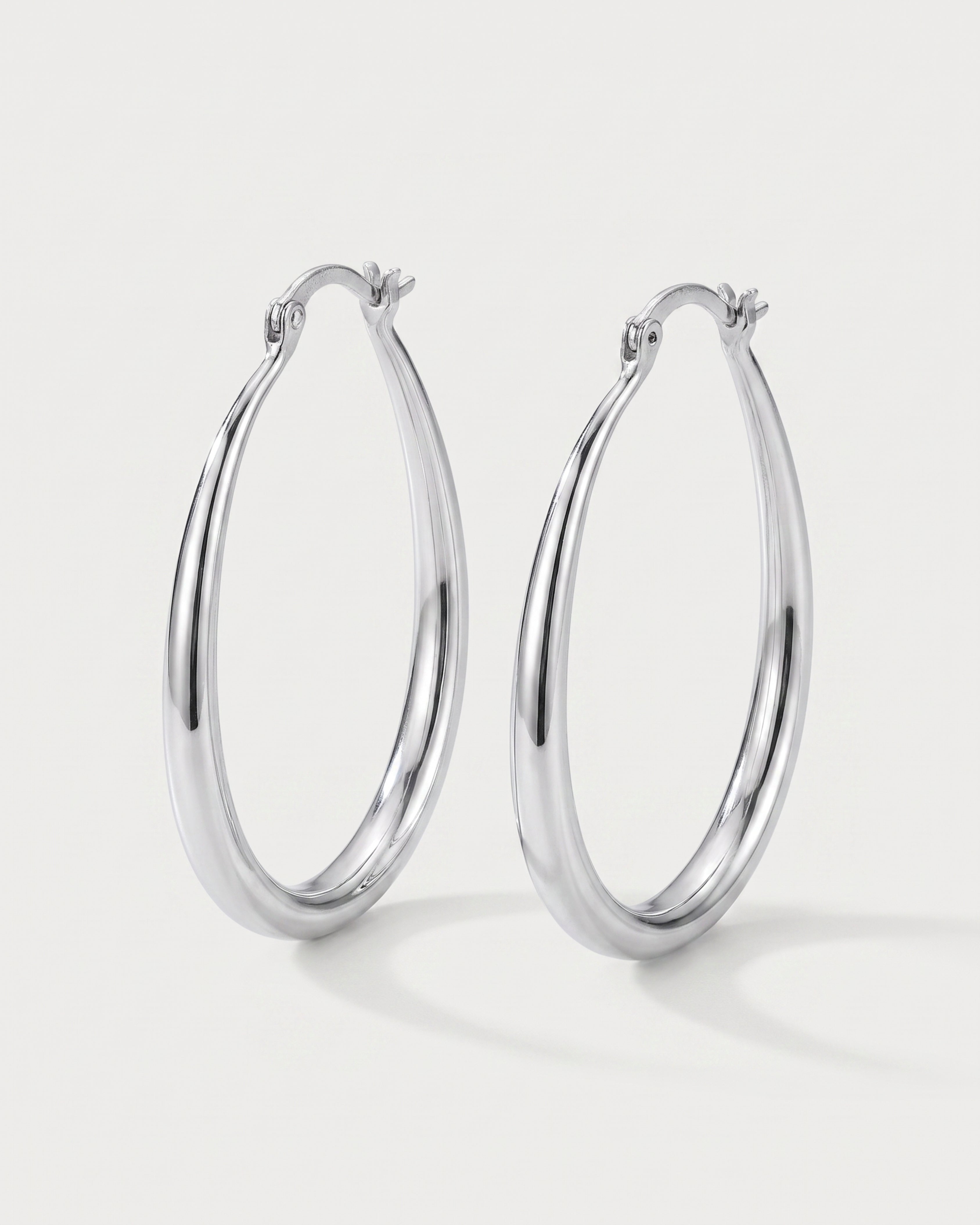 Geometric Oval Earrings in silver — three-quarter view, RABUKO
