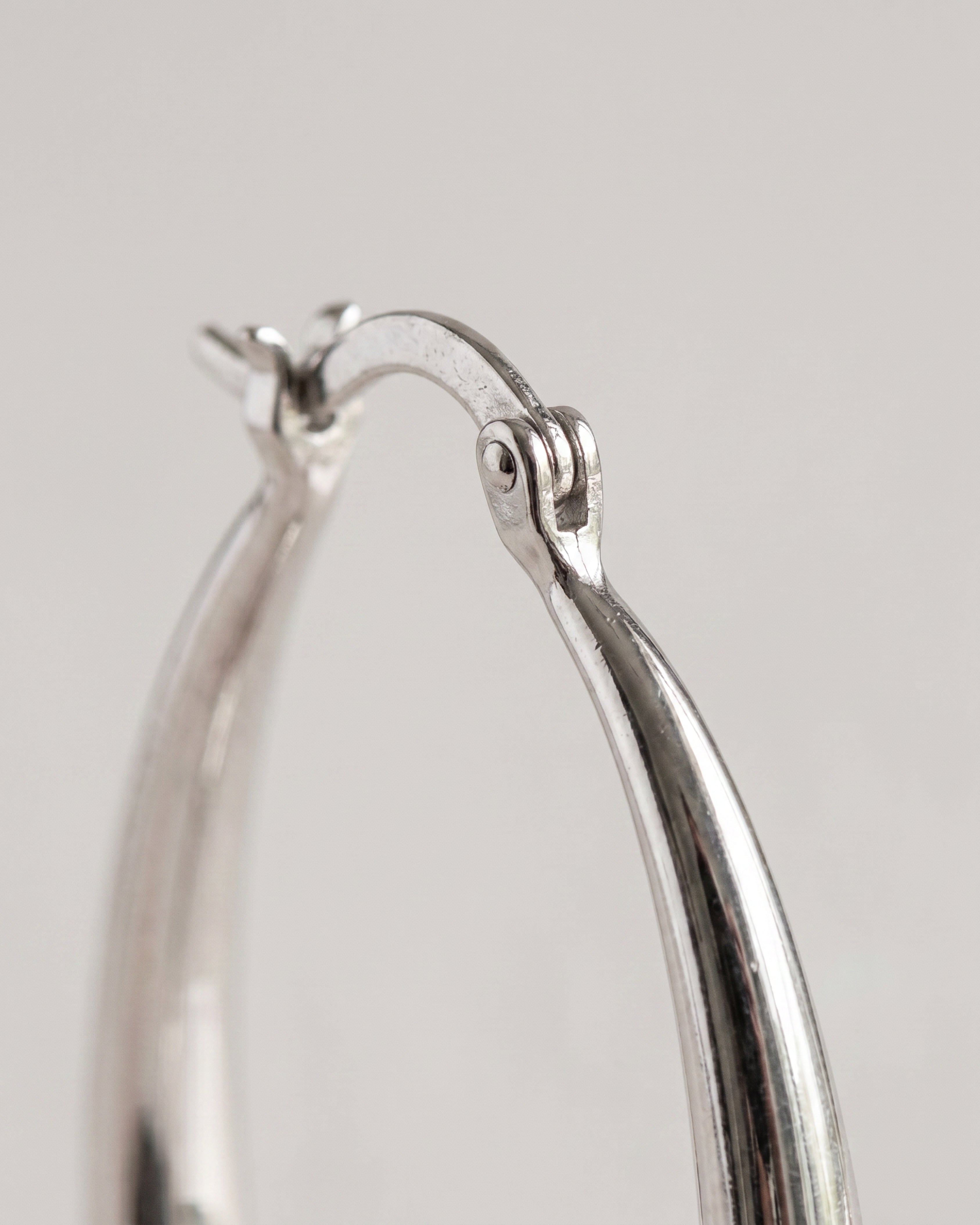 Geometric Oval Earrings in silver — macro detail, RABUKO