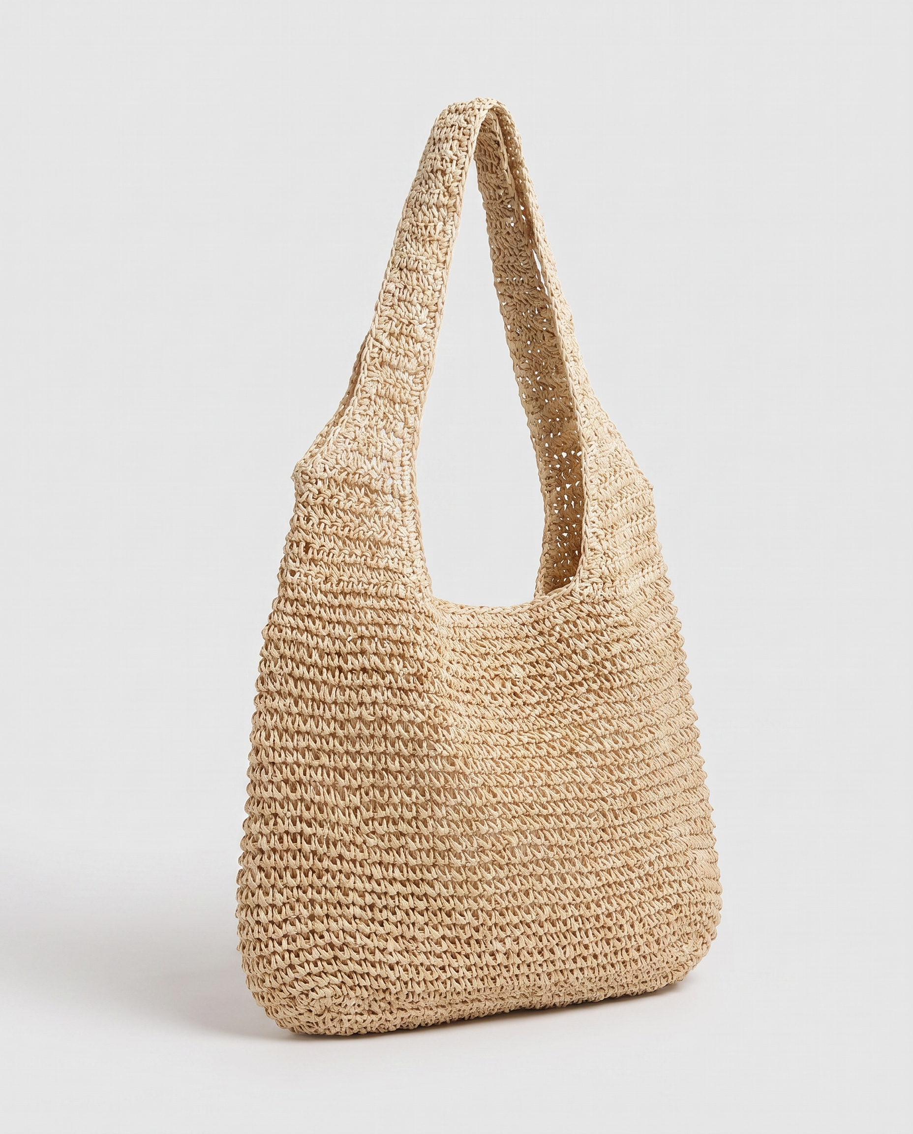 Large Woven Straw Bag in beige — three-quarter view, RABUKO