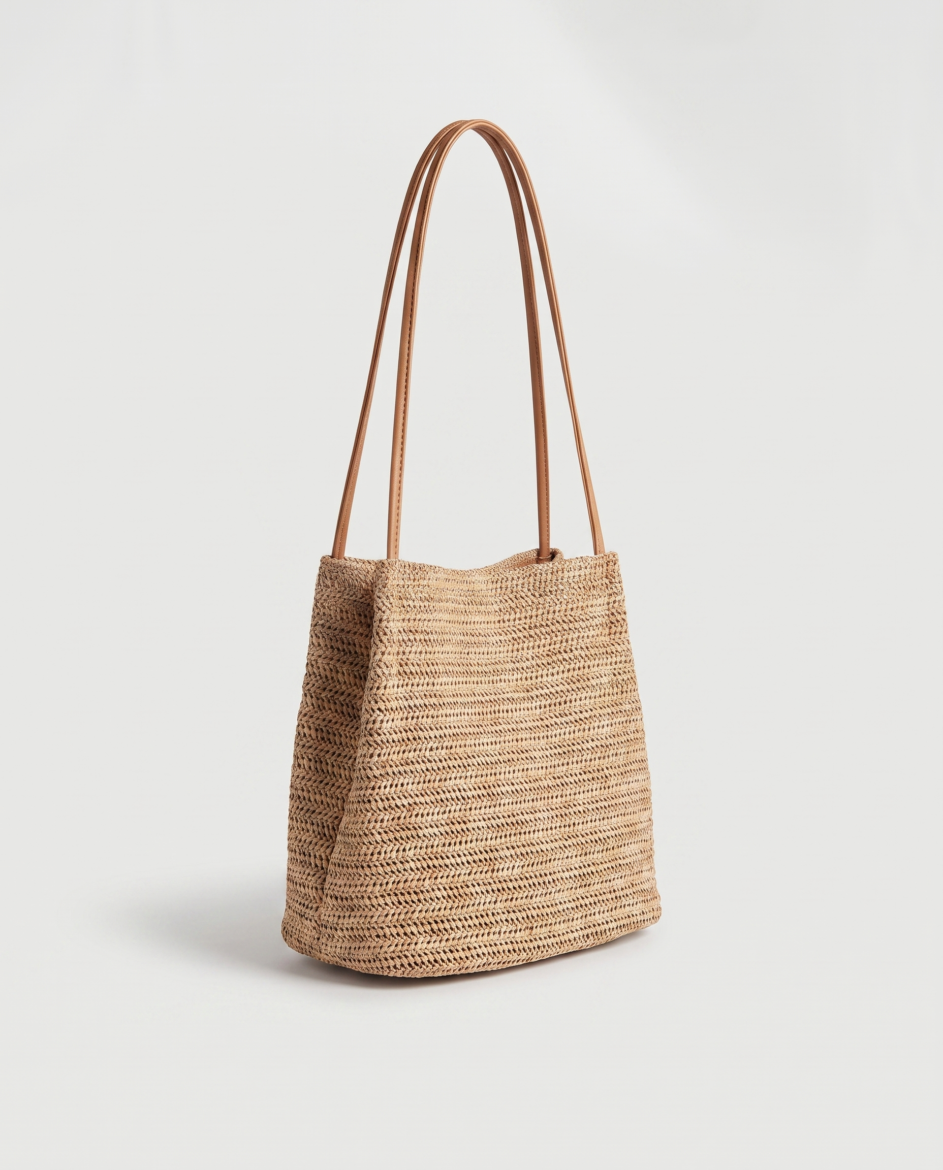 Mini Handwoven Straw Tote in dark beige — three-quarter view, RABUKO