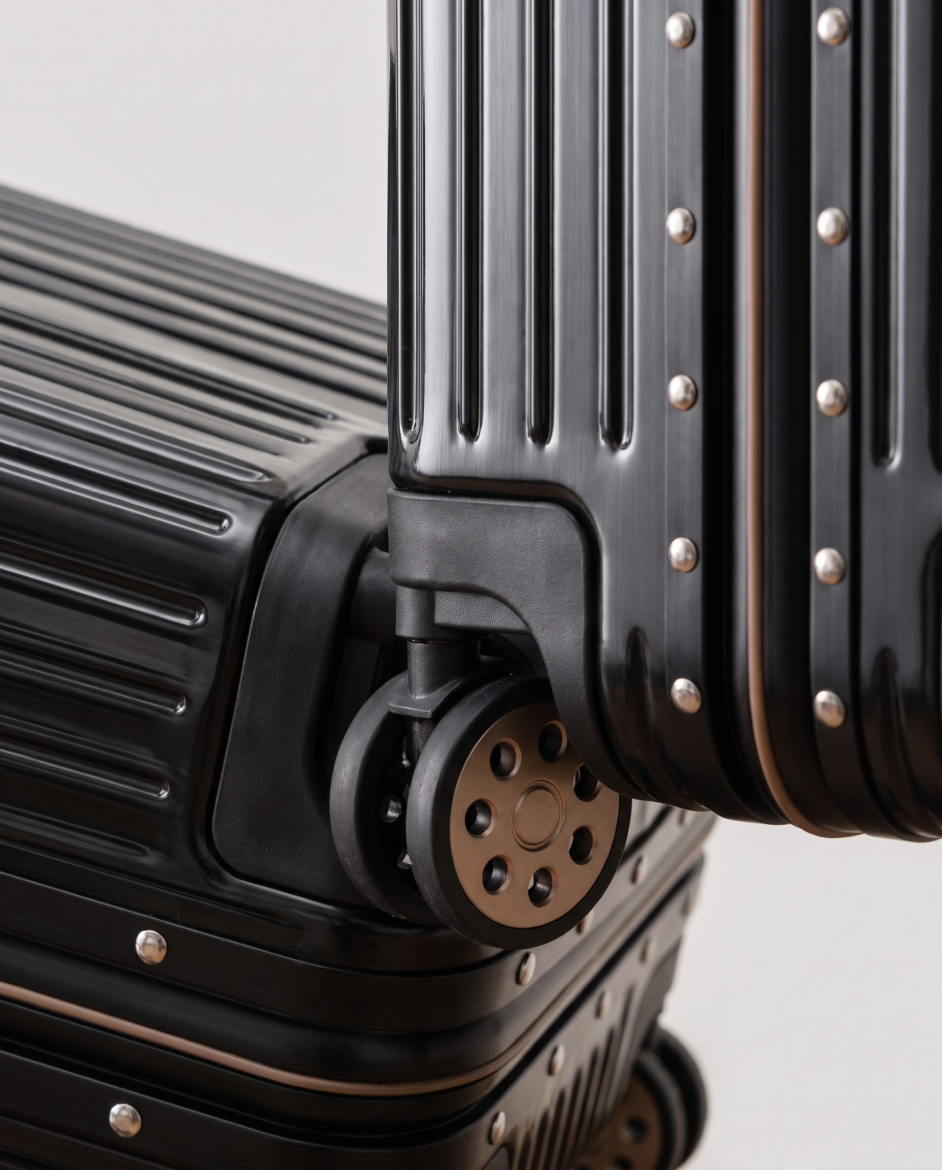 Aluminum frame suitcase in black — frame and wheel detail, RABUKO