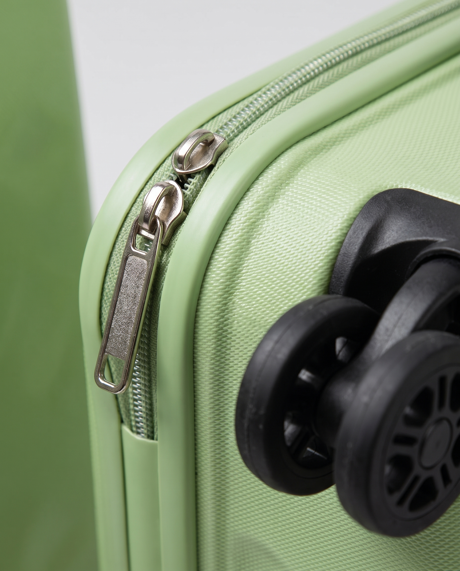 Foldable suitcase in green — wheel and zip detail, RABUKO