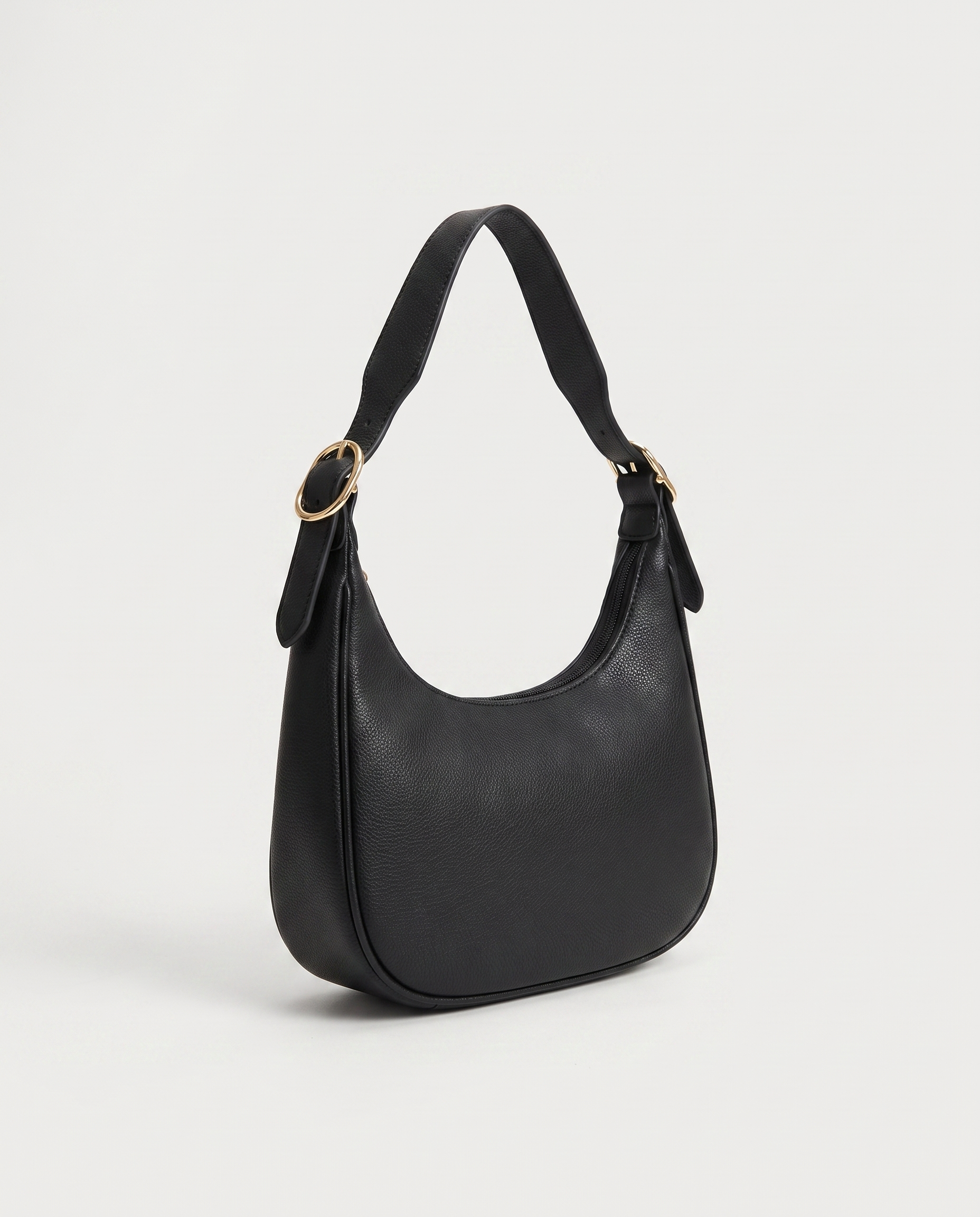 Crescent mini crossbody bag in black — three-quarter view, RABUKO