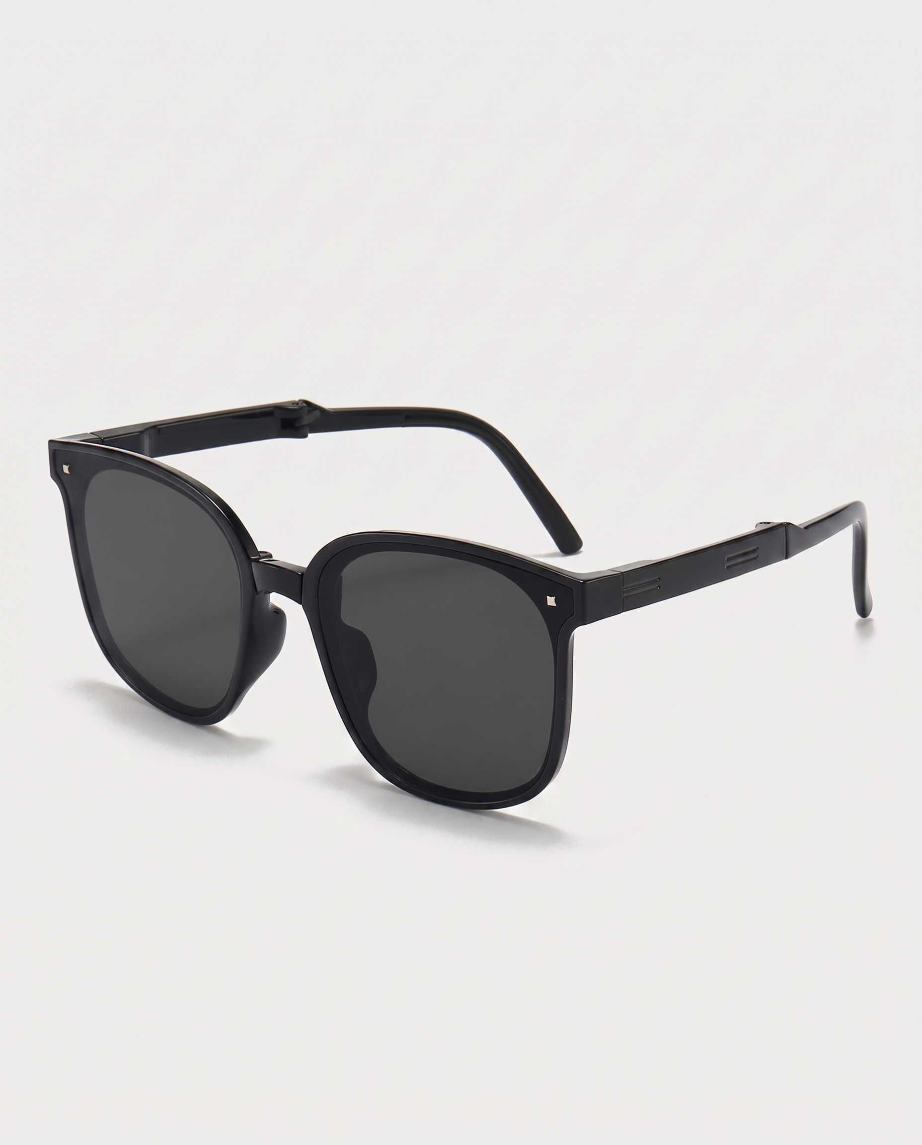 Folding sunglasses in black — three-quarter view, RABUKO