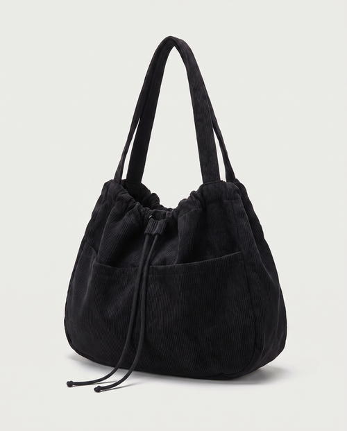 Corduroy drawstring bag in black — three-quarter view, RABUKO