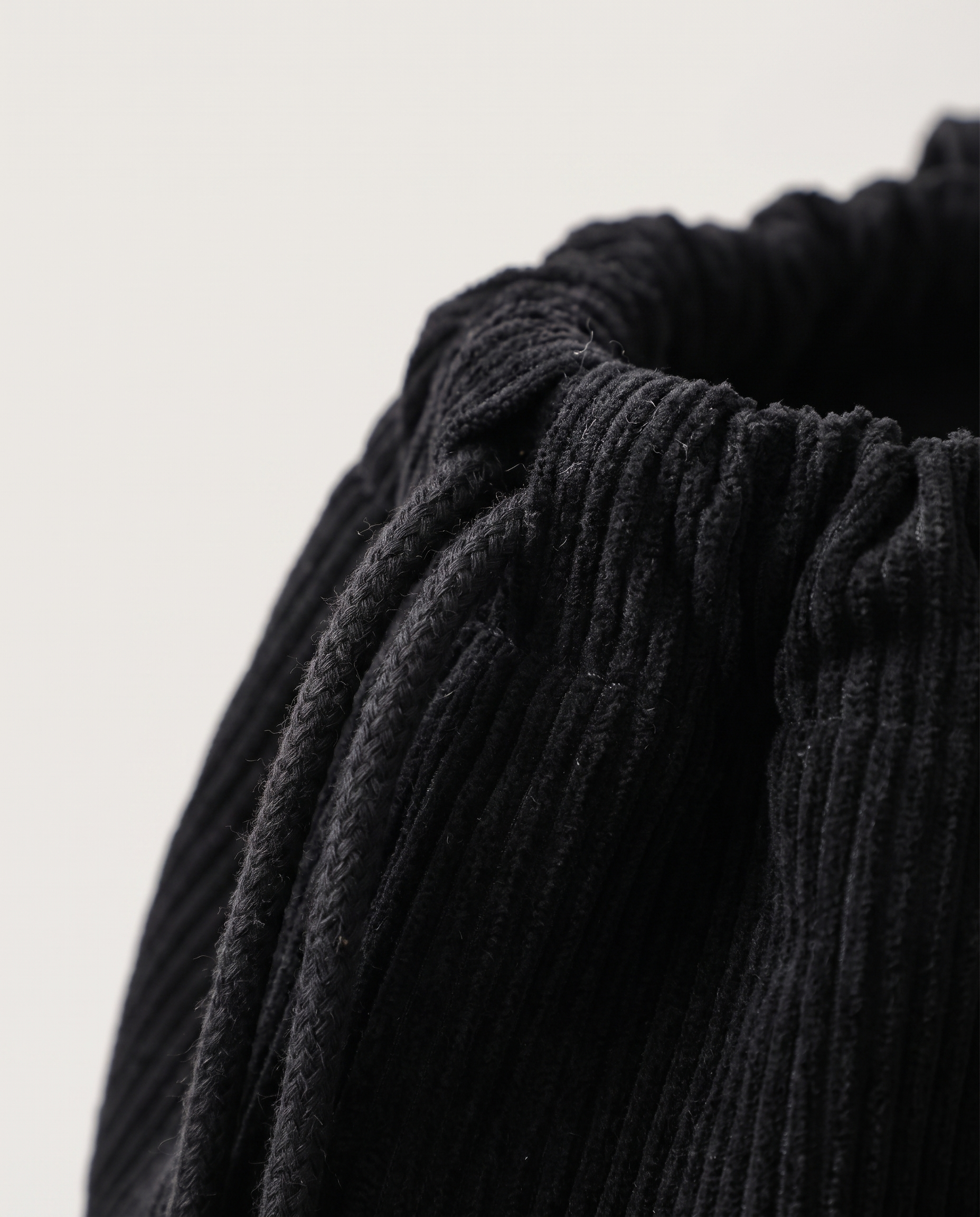 Corduroy drawstring bag in black — corduroy texture detail, RABUKO