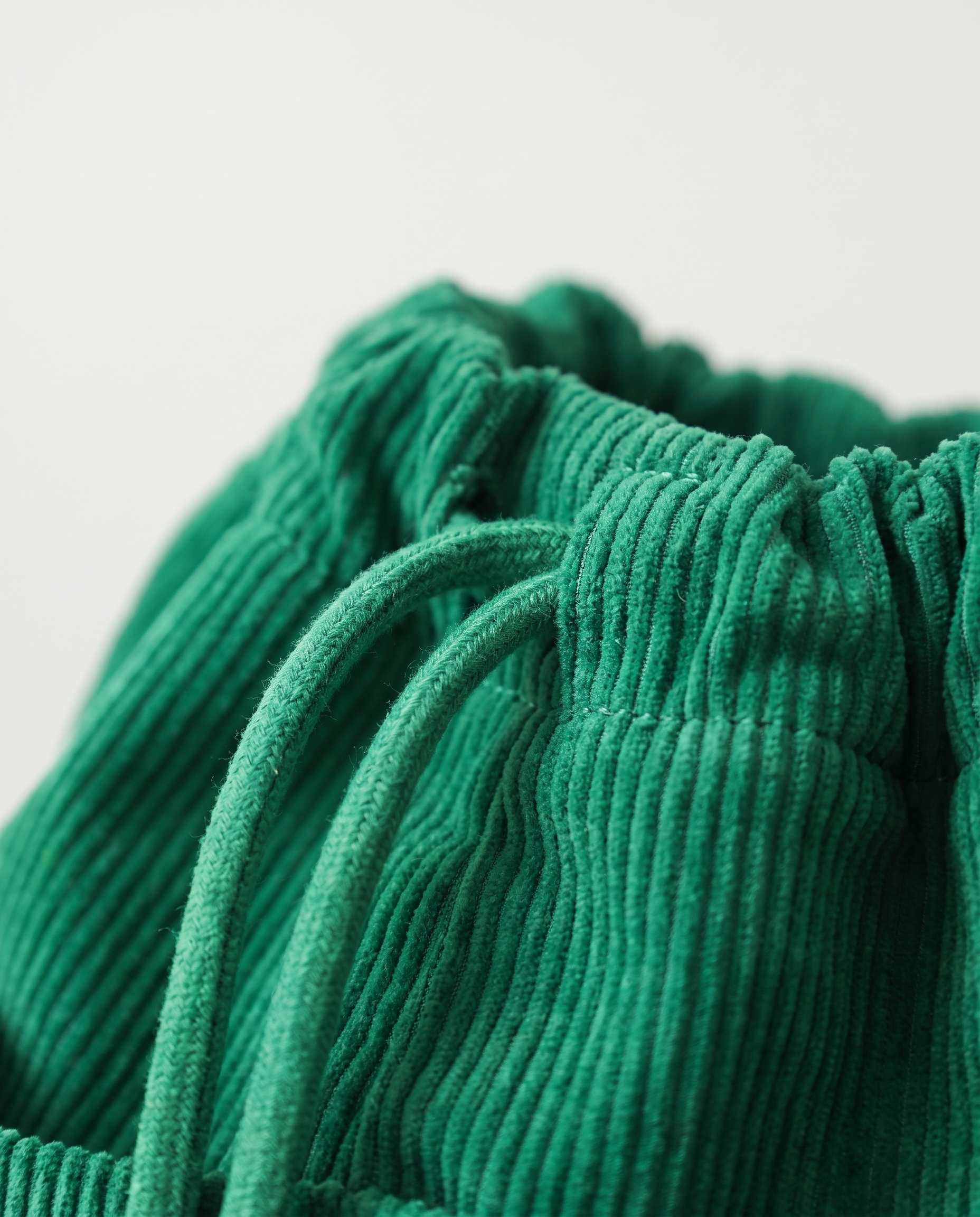 Corduroy drawstring bag in green — corduroy texture detail, RABUKO