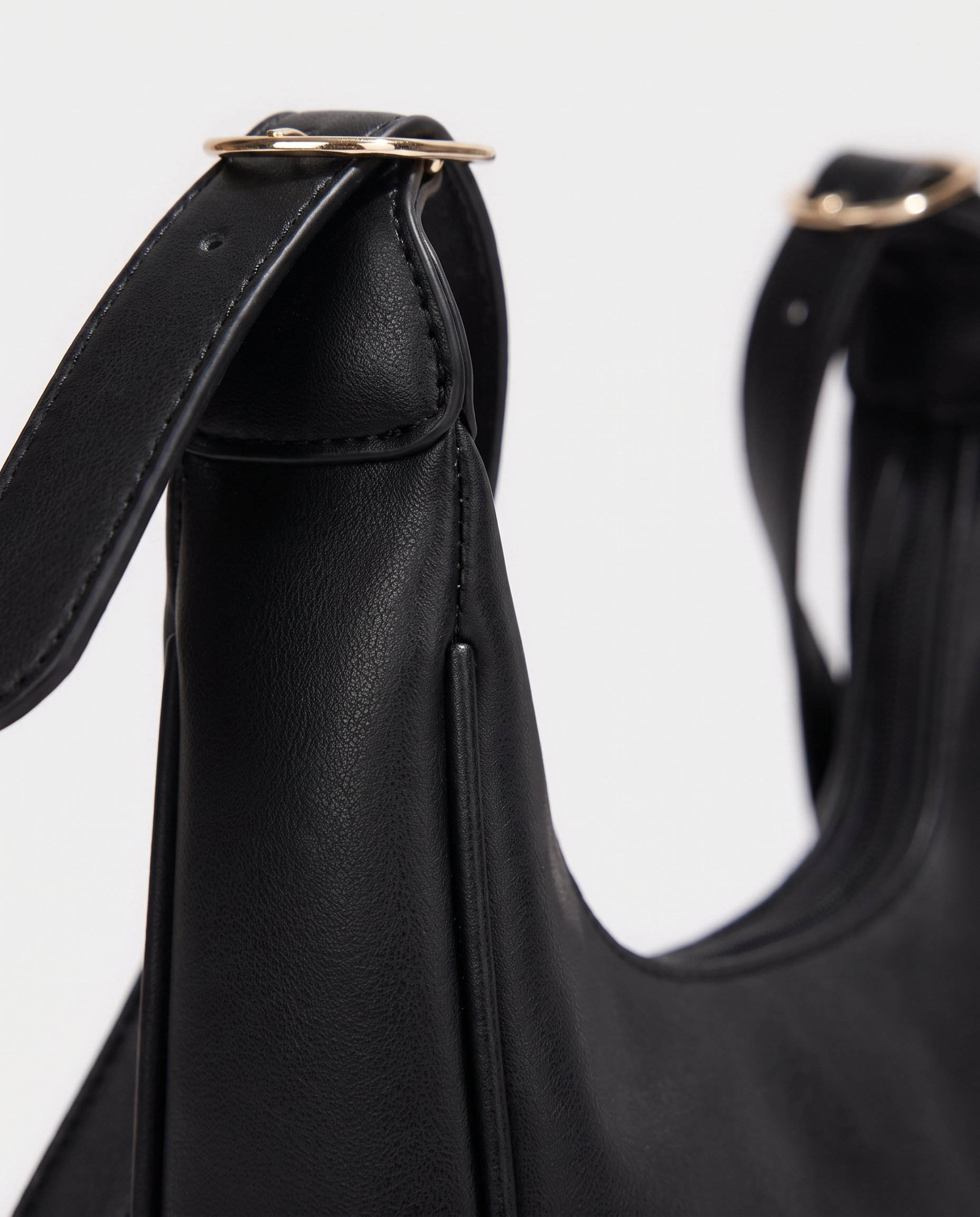 Crescent mini crossbody bag in black — texture detail, RABUKO